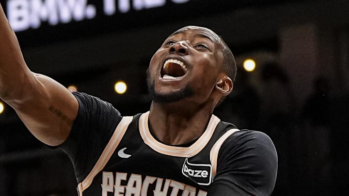 Atlanta Hawks forward Jonathan Kuminga (0) is called for an offensive foul on Orlando Magic guard Jalen Suggs (4) during the second half at State Farm Arena on March 16, 2026.
