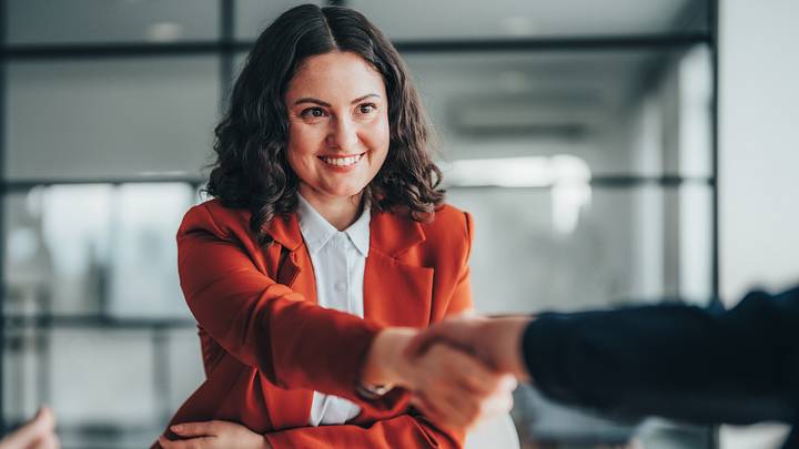 Businesswoman shaking hands with someone at work