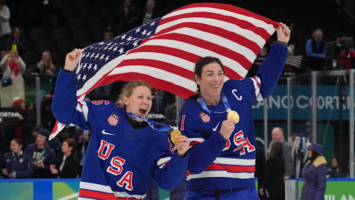 Feb 19, 2026; Milan, Italy; Kendall Coyne (26) of the United States and Hilary Knight (21) of the United States celebrate after winning the gold medal in women's ice hockey after defeating Canada during the Milano Cortina 2026 Olympic Winter Games at Milano Santagiulia Ice Hockey Arena. Mandatory Credit: Amber Searls-Imagn Images