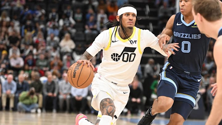Mar 12, 2025; Memphis, Tennessee, USA; Utah Jazz point guard Jordan Clarkson (00) drives in defender Memphis Grizzlies forward Jalen Wells (0) in the third quarter at FedExForum. Mandatory Credit: Matthew Smith-Imagn Images