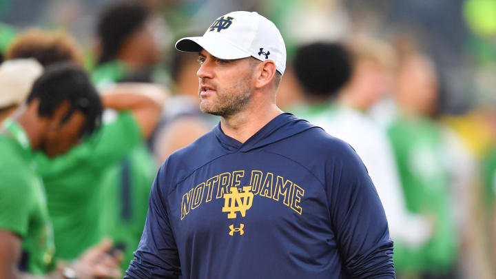 Sep 23, 2023; South Bend, Indiana, USA; Notre Dame Fighting Irish offensive coordinator Gerad Parker watches warmups before the game against the Ohio State Buckeyes at Notre Dame Stadium. 