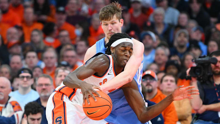 Feb 21, 2026; Syracuse, New York, USA; Syracuse Orange forward William Kyle III (42) drives against North Carolina Tar Heels center Henri Veesaar (13) during the first half at the JMA Wireless Dome. Mandatory Credit: Rich Barnes-Imagn Images