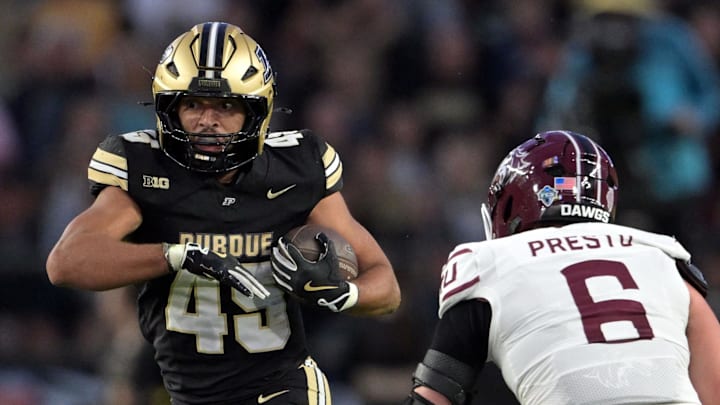 Purdue Boilermakers running back Devin Mockobee (45) runs past Southern Illinois Salukis linebacker Chris Presto (6)
