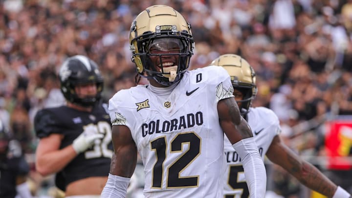 Sep 28, 2024; Orlando, Florida, USA; Colorado Buffaloes wide receiver Travis Hunter (12) scores a touchdown against the UCF Knights during the first quarter at FBC Mortgage Stadium. Mandatory Credit: Mike Watters-Imagn Images