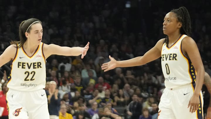 Jun 30, 2024; Phoenix, Ariz., U.S.; Indiana Fever guard Caitlin Clark (22) slaps hands with guard Kelsey Mitchell (0) during the third quarter against the Phoenix Mercury at Footprint Center. Mandatory Credit: Michael Chow-Arizona Republic Jun 30, 2024; Phoenix, Ariz., U.S.; Indiana Fever guard Caitlin Clark (22) slaps hands with guard Kelsey Mitchell (0) during the third quarter against the Phoenix Mercury at Footprint Center. Mandatory Credit: Michael Chow-Arizona Republic
