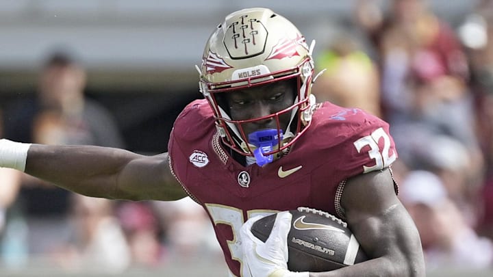 Oct 11, 2025; Tallahassee, Florida, USA; Florida State Seminoles running back Ousmane Kromah (32) is tackled by Pittsburgh Panthers linebacker Braylan Lovelace (0) during the second half at Doak S. Campbell Stadium. Mandatory Credit: Melina Myers-Imagn Images