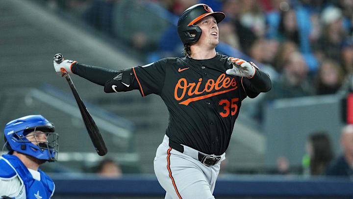 Mar 27, 2025; Toronto, Ontario, CAN; Baltimore Orioles catcher Adley Rutschman (35) hits a home run against the Toronto Blue Jays during the first inning at Rogers Centre Mar 27, 2025; Toronto, Ontario, CAN; Baltimore Orioles catcher Adley Rutschman (35) hits a home run against the Toronto Blue Jays during the first inning at Rogers Centre