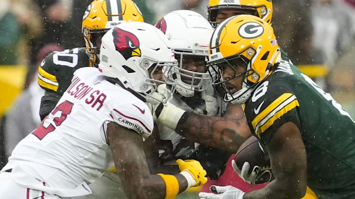 Green Bay Packers running back Josh Jacobs (8) rushes with the football against the Cardinals last season. Green Bay Packers running back Josh Jacobs (8) rushes with the football against the Cardinals last season.