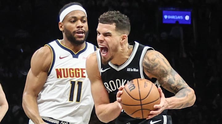 Jan 4, 2026; Brooklyn, New York, USA;  Brooklyn Nets forward Michael Porter Jr. (17) looks to drive past Denver Nuggets guard Bruce Brown (11) in the third quarter at Barclays Center. Mandatory Credit: Wendell Cruz-Imagn Images