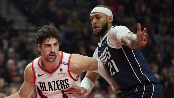 Dec 28, 2024; Portland, Oregon, USA; Portland Trail Blazers forward Deni Avdija (8) drives past Dallas Mavericks center Daniel Gafford (21) during the first half at Moda Center. Mandatory Credit: Troy Wayrynen-Imagn Images