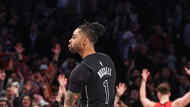 Feb 4, 2025; Brooklyn, New York, USA; Brooklyn Nets guard D'Angelo Russell (1) reacts after makes a three point basket during the fourth quarter against the Houston Rockets at Barclays Center. Mandatory Credit: Vincent Carchietta-Imagn Images