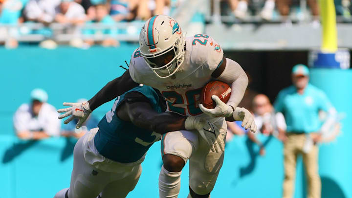 Sep 8, 2024; Miami Gardens, Florida, USA; Miami Dolphins running back De'Von Achane (28) runs with the football against the Jacksonville Jaguars during the fourth quarter at Hard Rock Stadium. Mandatory Credit: Sam Navarro-Imagn Images