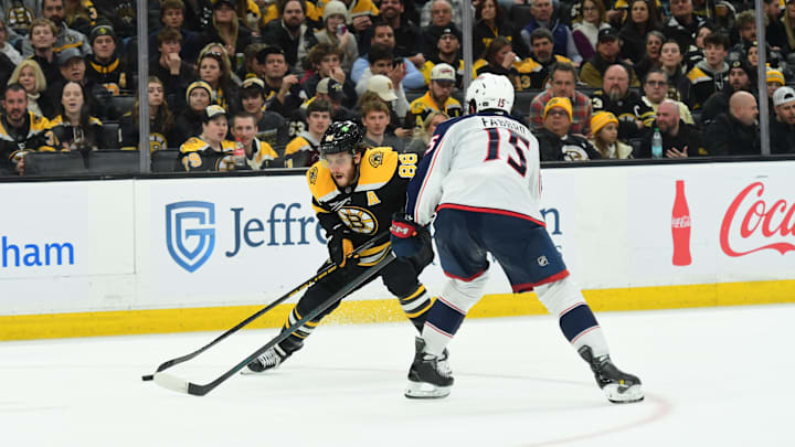 Blue Jackets defenseman Dante Fabbro defends Bruins forward David Pastrnak. Blue Jackets defenseman Dante Fabbro defends Bruins forward David Pastrnak.