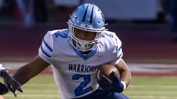 Central Valley running back Jance Henry (2) looks to make a move around Avonworth defensive back Billy Onyshko (13) during the Warriors Western Hills Conference matchup against Avonworth Friday night at Lenzner Field.