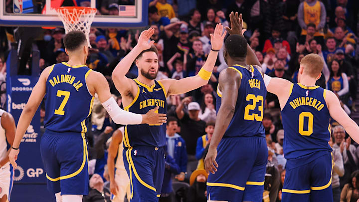 Jan 4, 2023; San Francisco, California, USA; Golden State Warriors shooting guard Klay Thompson (11) celebrates with small forward Patrick Baldwin (7), power forward Draymond Green (23) and shooting guard Donte DiVincenzo (0) after a play against the Detroit Pistons during the fourth quarter at Chase Center. Mandatory Credit: Kelley L Cox-Imagn Images