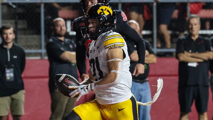 Sep 19, 2025; Piscataway, New Jersey, USA; Iowa Hawkeyes wide receiver Kaden Wetjen (21) returns the opening kick off for a touchdown during the first quarter against the Rutgers Scarlet Knights at SHI Stadium. Mandatory Credit: Vincent Carchietta-Imagn Images