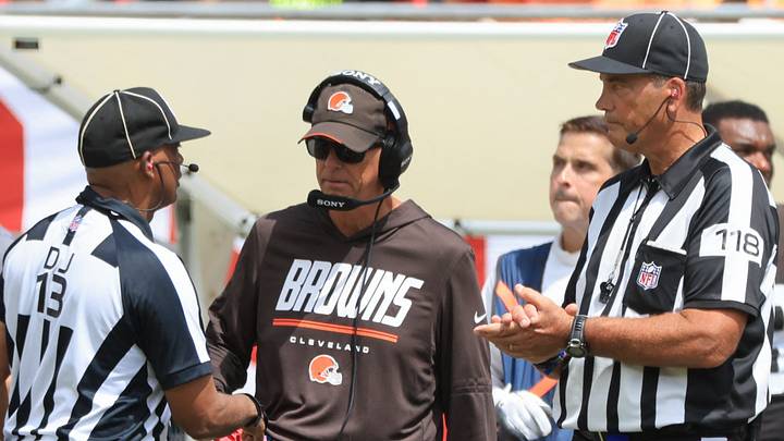  Cleveland Browns head coach Todd Monken talks with a referee.