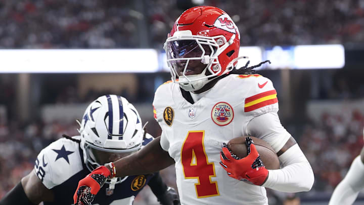 Nov 27, 2025; Arlington, Texas, USA; Kansas City Chiefs wide receiver Rashee Rice (4) runs with the ball past Dallas Cowboys safety Malik Hooker (28) during the first quarter at AT&T Stadium. Mandatory Credit: Kevin Jairaj-Imagn Images