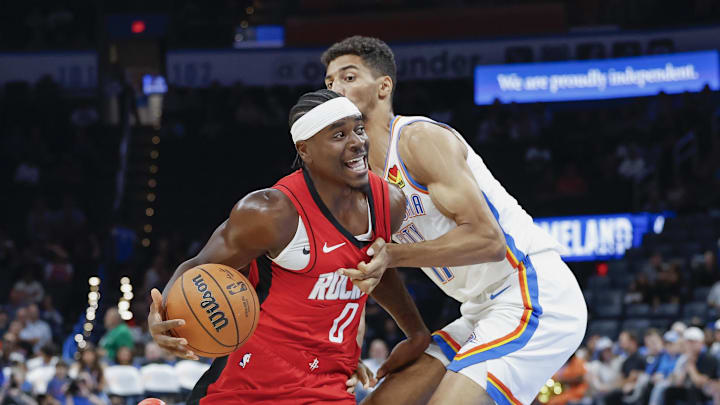 Oct 9, 2024; Oklahoma City, Oklahoma, USA; Houston Rockets guard Aaron Holiday (0) drives to the basket against Oklahoma City Thunder forward Malevy Leons (17) during the second half at Paycom Center. Mandatory Credit: Alonzo Adams-Imagn Images