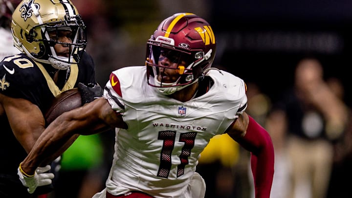 Dec 15, 2024; New Orleans, Louisiana, USA;  Washington Commanders safety Jeremy Chinn (11) tackles New Orleans Saints wide receiver Marquez Valdes-Scantling (10) during the second half at Caesars Superdome. Mandatory Credit: Stephen Lew-Imagn Images