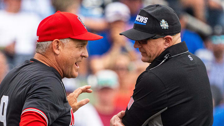 Jun 15, 2024; Omaha, NE, USA; NC State Wolfpack head coach Elliott Avent talks with an official during the seventh inning against the Kentucky Wildcats at Charles Schwab Field Omaha. Mandatory Credit: Dylan Widger-Imagn Images