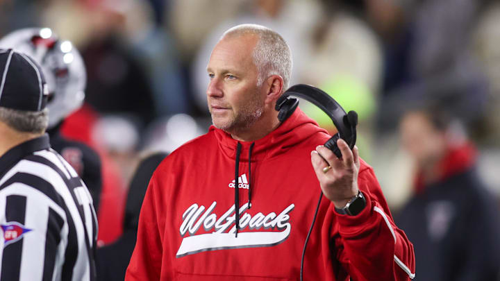 Nov 21, 2024; Atlanta, Georgia, USA; North Carolina State Wolfpack head coach Dave Doeren talks to a referee against the Georgia Tech Yellow Jackets in the fourth quarter at Bobby Dodd Stadium at Hyundai Field. Mandatory Credit: Brett Davis-Imagn Images