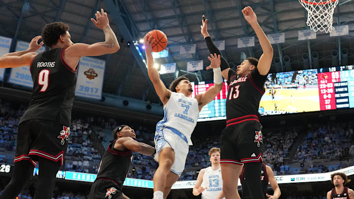 Feb 23, 2026; Chapel Hill, North Carolina, USA; North Carolina Tar Heels guard Seth Trimble (7) shoots as Louisville Cardinals forward Khani Rooths (9) and guard Ryan Conwell (3) and forward Sananda Fru (13) defend in the second half at Dean E. Smith Center. Mandatory Credit: Bob Donnan-Imagn Images Feb 23, 2026; Chapel Hill, North Carolina, USA; North Carolina Tar Heels guard Seth Trimble (7) shoots as Louisville Cardinals forward Khani Rooths (9) and guard Ryan Conwell (3) and forward Sananda Fru (13) defend in the second half at Dean E. Smith Center. Mandatory Credit: Bob Donnan-Imagn Images