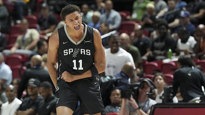 Jul 10, 2025; Las Vegas, NV, USA; San Antonio Spurs forward Carter Bryant (11) reacts to a play against the Philadelphia 76ers in the first quarter of their game at Thomas & Mack Center.