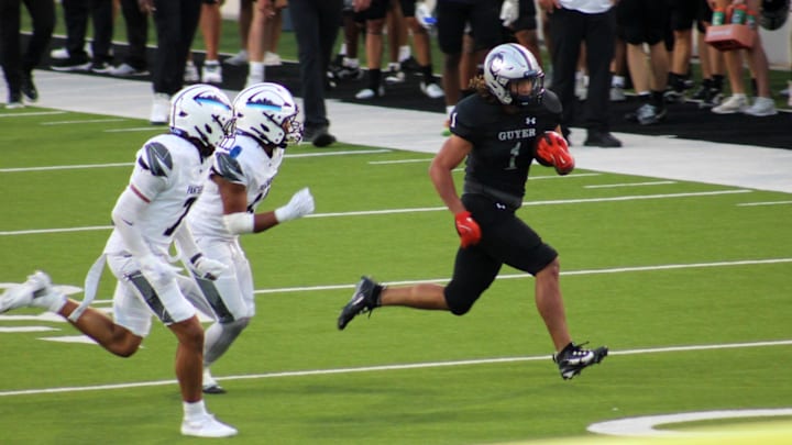 Denton Guyer's Kaedyn Cobbs, right, runs away from two North Crowley defenders in a game Friday at C.H. Collins Athletic Complex in Denton. 