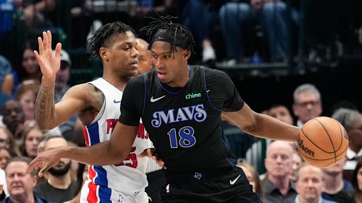 Apr 12, 2024; Dallas, Texas, USA; Dallas Mavericks forward Olivier-Maxence Prosper (18) controls the ball as Detroit Pistons guard Marcus Sasser (25) defends during the second half at American Airlines Center. Mandatory Credit: Chris Jones-Imagn Images