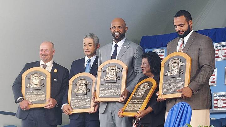 Inductees Billy Wagner, Ichiro Suzuki and CC Sabathia, Willa Allen, widow of Dick Allen, and David Parker II, son of Dave Parker (from left) pose with plaques at the conclusion of the Baseball Hall of Fame's annual induction ceremony Sunday, July 27, 2025, at Clark Sports Center in Cooperstown, New York.