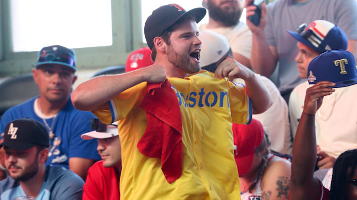 ; A Boston Red Sox fan reacts during the first round of the MLB Draft at Cowtown Coliseum.