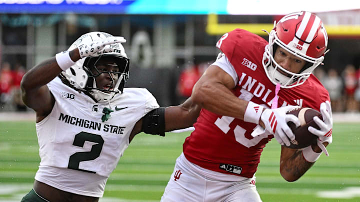 Oct 18, 2025; Bloomington, Indiana, USA; Indiana Hoosiers wide receiver Elijah Sarratt (13) catches a pass for a touchdown against Michigan State Spartans defensive back Aydan West (2) during the second half at Memorial Stadium. Mandatory Credit: Robert Goddin-Imagn Images