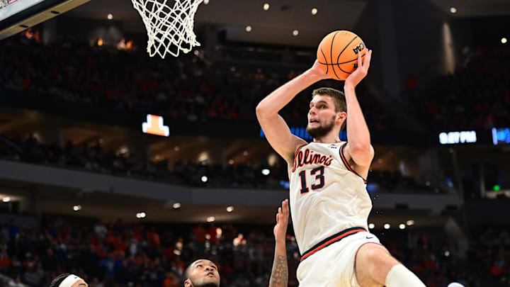 Mar 21, 2025; Milwaukee, WI, USA: Illinois Fighting Illini center Tomislav Ivisic (13) drives to the hoop past Xavier Musketeers guard Dayvion McKnight (20) during the first half at Fiserv Forum. Mandatory Credit: Benny Sieu-Imagn Images