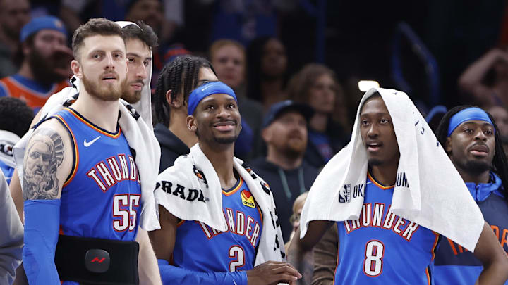 Feb 10, 2025; Oklahoma City, Oklahoma, USA; Oklahoma City Thunder guard Isaiah Joe (11), center Isaiah Hartenstein (55), forward Chet Holmgren (7), guard Shai Gilgeous-Alexander (2), forward Jalen Williams (8) and guard Luguentz Dort (5) watch the end of a game against the New Orleans Pelicans at Paycom Center. Mandatory Credit: Alonzo Adams-Imagn Images