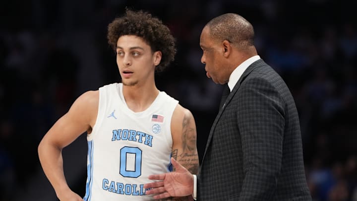 Mar 12, 2026; Charlotte, NC, USA; North Carolina Tar Heels head coach Hubert Davis with guard Kyan Evans (0) in the first half at Spectrum Center. Mandatory Credit: Bob Donnan-Imagn Images Mar 12, 2026; Charlotte, NC, USA; North Carolina Tar Heels head coach Hubert Davis with guard Kyan Evans (0) in the first half at Spectrum Center. Mandatory Credit: Bob Donnan-Imagn Images