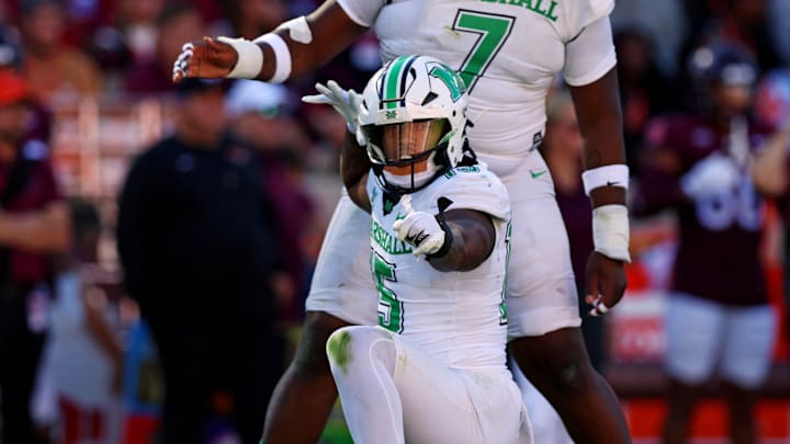 Marshall Thundering Herd defensive lineman Mike Green celebrates after sacking Virginia Tech Hokies quarterback Kyron Drones.