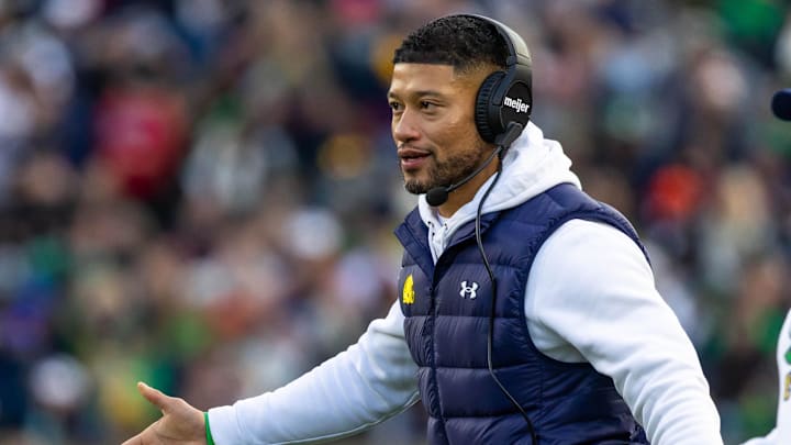 Nov 22, 2025; South Bend, Indiana, USA; Notre Dame Fighting Irish head coach Marcus Freeman celebrates with players after scoring against the Syracuse Orange during the first half at Notre Dame Stadium. 