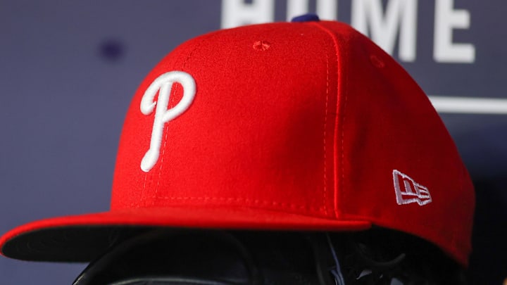 May 26, 2023; Atlanta, Georgia, USA; A detailed view of a Philadelphia Phillies hat and glove on the bench against the Atlanta Braves in the seventh inning at Truist Park. 