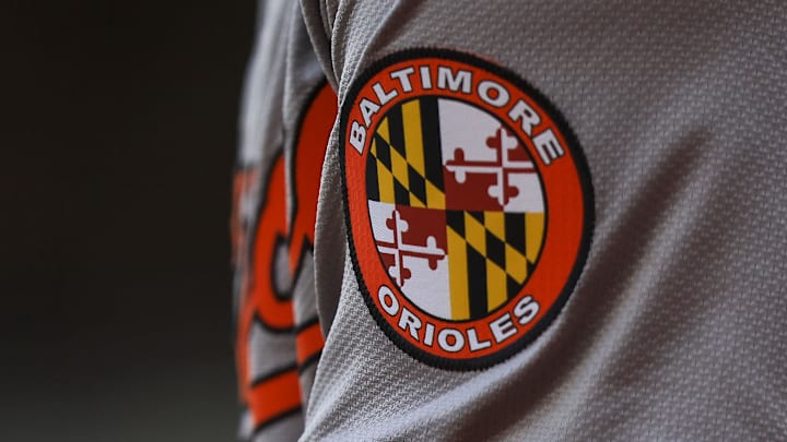 May 5, 2024; Cincinnati, Ohio, USA; The Baltimore Orioles logo on the sleeve of designated hitter Gunnar Henderson (2) as he prepares on deck during the seventh inning against the Cincinnati Reds at Great American Ball Park. Mandatory Credit: Katie Stratman-Imagn Images May 5, 2024; Cincinnati, Ohio, USA; The Baltimore Orioles logo on the sleeve of designated hitter Gunnar Henderson (2) as he prepares on deck during the seventh inning against the Cincinnati Reds at Great American Ball Park. Mandatory Credit: Katie Stratman-Imagn Images