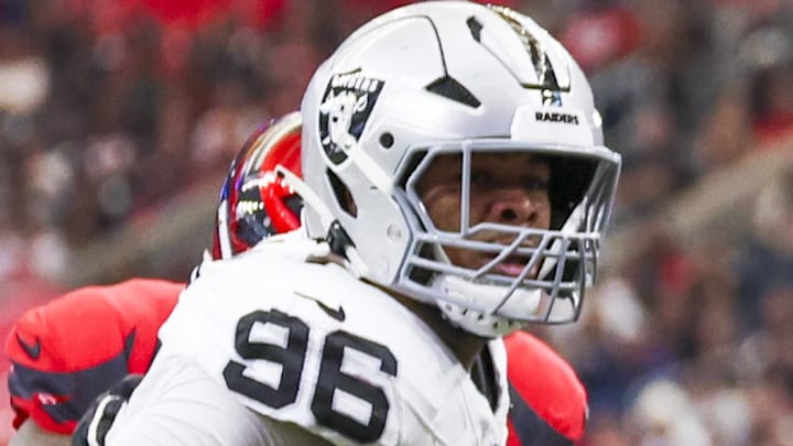 Dec 21, 2025; Houston, Texas, USA; Houston Texans quarterback C.J. Stroud (7) spins away from a potential sack by Las Vegas Raiders defensive tackle Jonah Laulu (96) during the first quarter at NRG Stadium. Mandatory Credit: Thomas Shea-Imagn Images