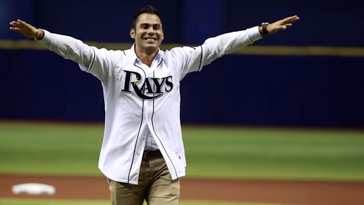 Tampa Bay Rays former player Carlos Pena is signed for a day as he officially retires from Major League Baseball as a Ray and throws out the first pitch before the game against the Baltimore Orioles at Tropicana Field. Tampa Bay Rays former player Carlos Pena is signed for a day as he officially retires from Major League Baseball as a Ray and throws out the first pitch before the game against the Baltimore Orioles at Tropicana Field.