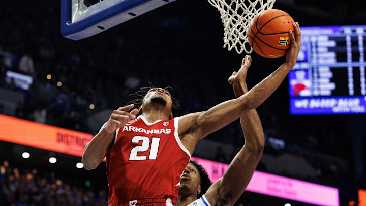 Arkansas Razorbacks guard D.J. Wagner scores on a reverse left-hand layup  goes to the basket against Kentucky Wildcats center Amari Williams during the Hogs' 89-79 upset win in Rupp Arena on Saturday.