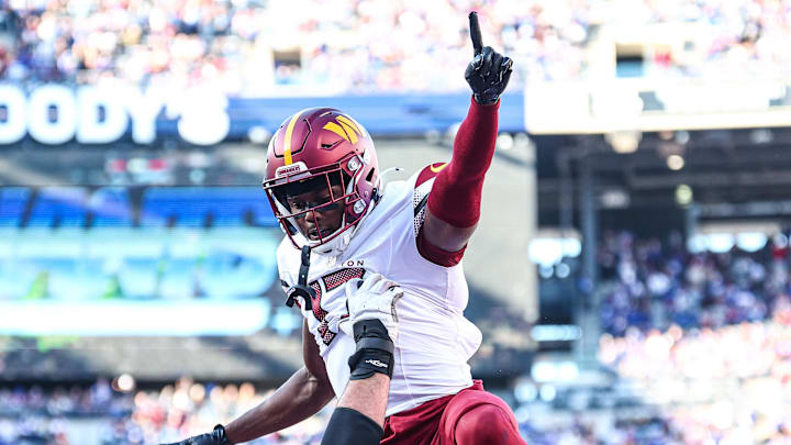 Nov 3, 2024; East Rutherford, New Jersey, USA;  Washington Commanders wide receiver Terry McLaurin (17) celebrates after a touchdown reception with guard Sam Cosmi (76) during the first half against the New York Giants at MetLife Stadium. Mandatory Credit: Vincent Carchietta-Imagn Images