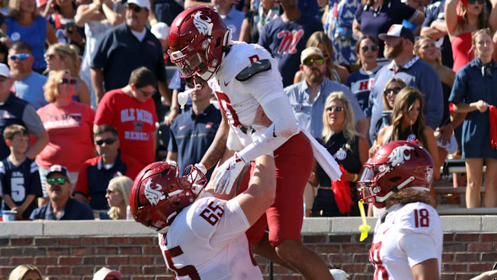 Washington State Cougars offensive lineman Brock Dieu (65) lifts wide receiver Tony Freeman (0) after a touchdown during the fourth quarter om at Vaught-Hemingway Stadium. Washington State Cougars offensive lineman Brock Dieu (65) lifts wide receiver Tony Freeman (0) after a touchdown during the fourth quarter om at Vaught-Hemingway Stadium.
