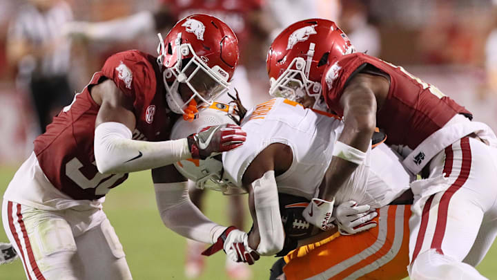  Tennessee Volunteers wide receiver Don’t Thornton Jr. (1) is tackled by Arkansas Razorbacks linebacker Larry Worth III (30) and defensive back Hudson Clark (18) during the fourth quarter at Razorback Stadium.