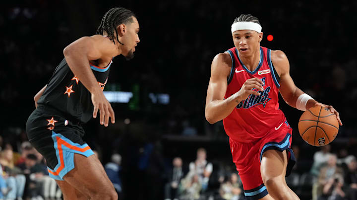 Feb 13, 2026; Inglewood, California, USA; Team Vince frontcourt Carter Bryant (11) of the San Antonio Spurs controls the ball during an NBA All Star Rising Stars game at Intuit Dome.