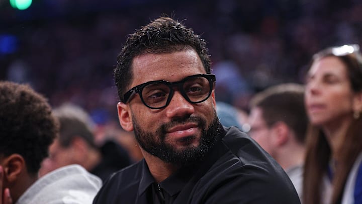 Former Seattle Seahawks quarterback Russell Wilson sits court-side