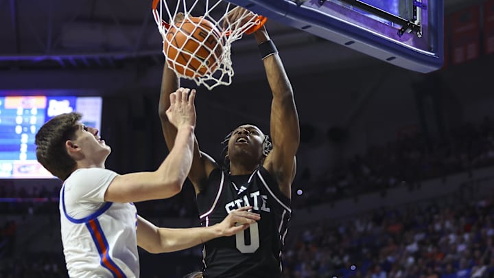 Mississippi State Bulldogs forward Jamarion Davis-Fleming (0) dunks over Florida Gators forward Alex Condon (21) during the first half at Exactech Arena at the Stephen C. O'Connell Center.
