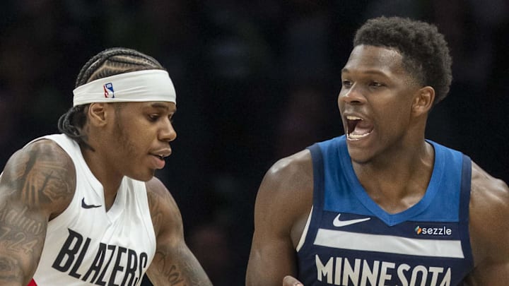 Minnesota Timberwolves guard Anthony Edwards dribbles the ball as Portland Trail Blazers guard Javonte Cooke plays defense.